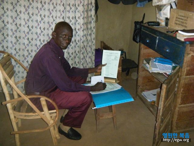 5. Sam in Ingbokolo Office.jpg